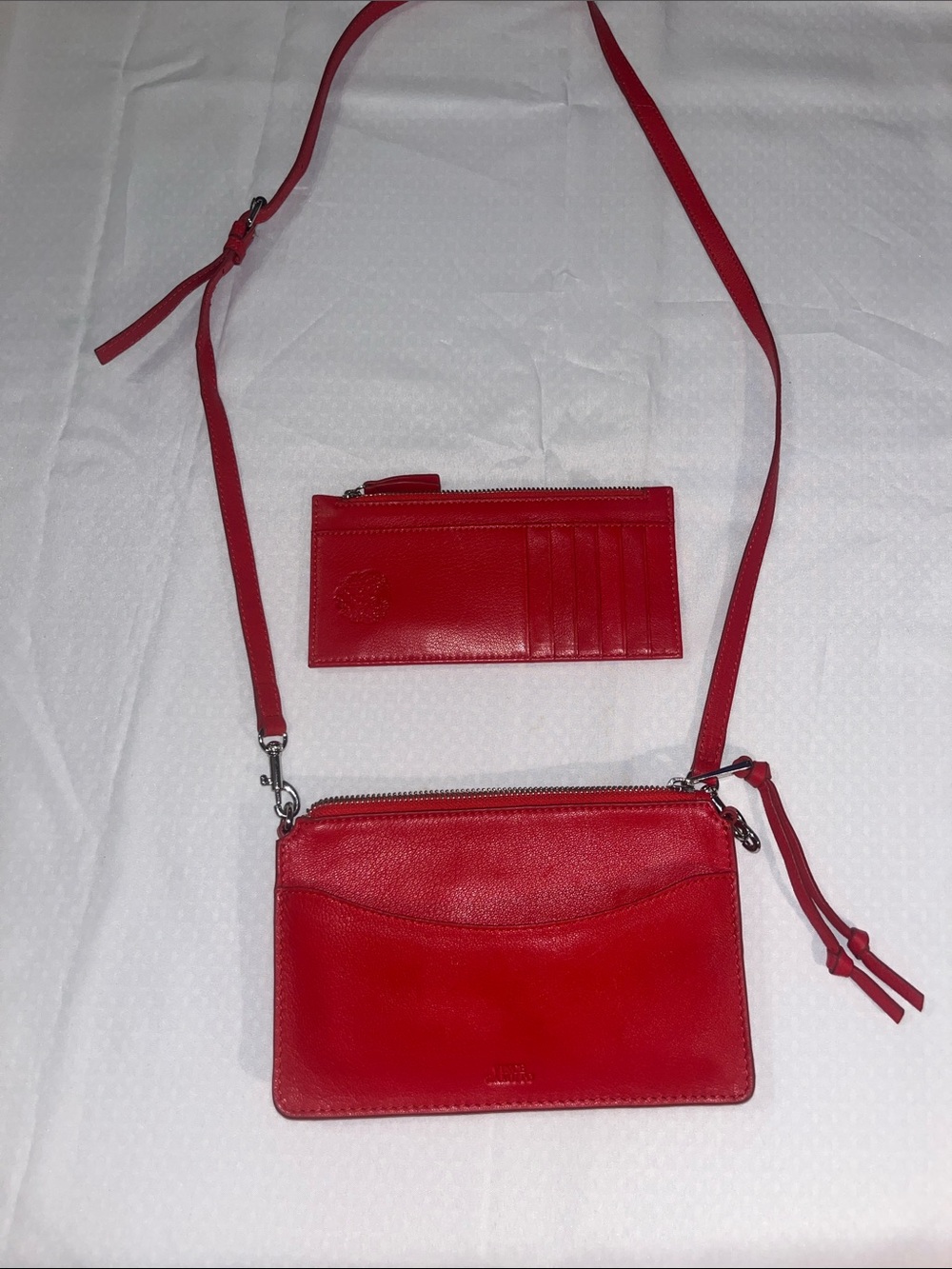 Sleek Vince Camuto crossbody in vibrant red leather Detachable strap card holder